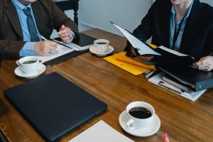 crop colleagues discussing business project in workspace